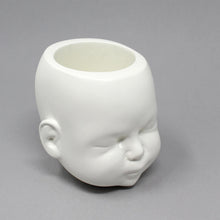 Load image into Gallery viewer, doll head pot in white shown at side angle on grey background, showing detailed ears and face