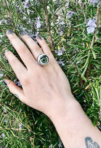 green blinking eye ring shown on ring finger worn by model