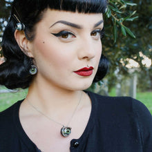 Load image into Gallery viewer, pin up model wearing classic makeup and black hair wears matching necklace and earrings et of the green doll eyes