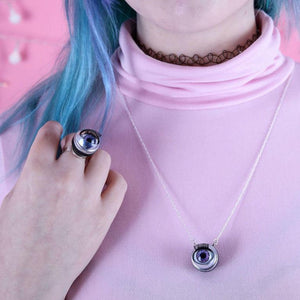 purple doll eye necklace shown on model with long chain on bubblehum pink top, modelled with purple doll eye ring