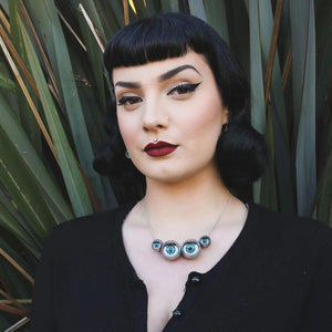 spider necklace being worn by alt/ pin up/ goth model 