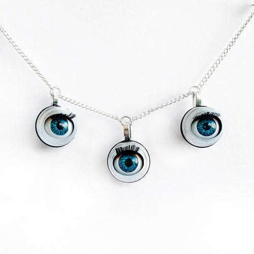 triple eye necklace by jawline jewellery 3 blinking blue doll eyes necklace creepy cute doll parts witchy macabre alternative gothic pastel goth steampunk necklace 