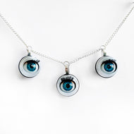 triple eye necklace by jawline jewellery 3 blinking blue doll eyes necklace creepy cute doll parts witchy macabre alternative gothic pastel goth steampunk necklace 