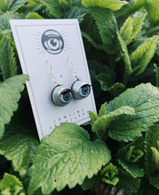 Load image into Gallery viewer, doll eye earrings shown on lemon balm plant